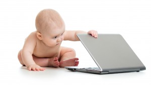 funny baby playing on notebook