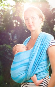Woman with newborn baby in sling